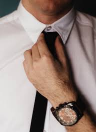 Man tying neck tie looks professional